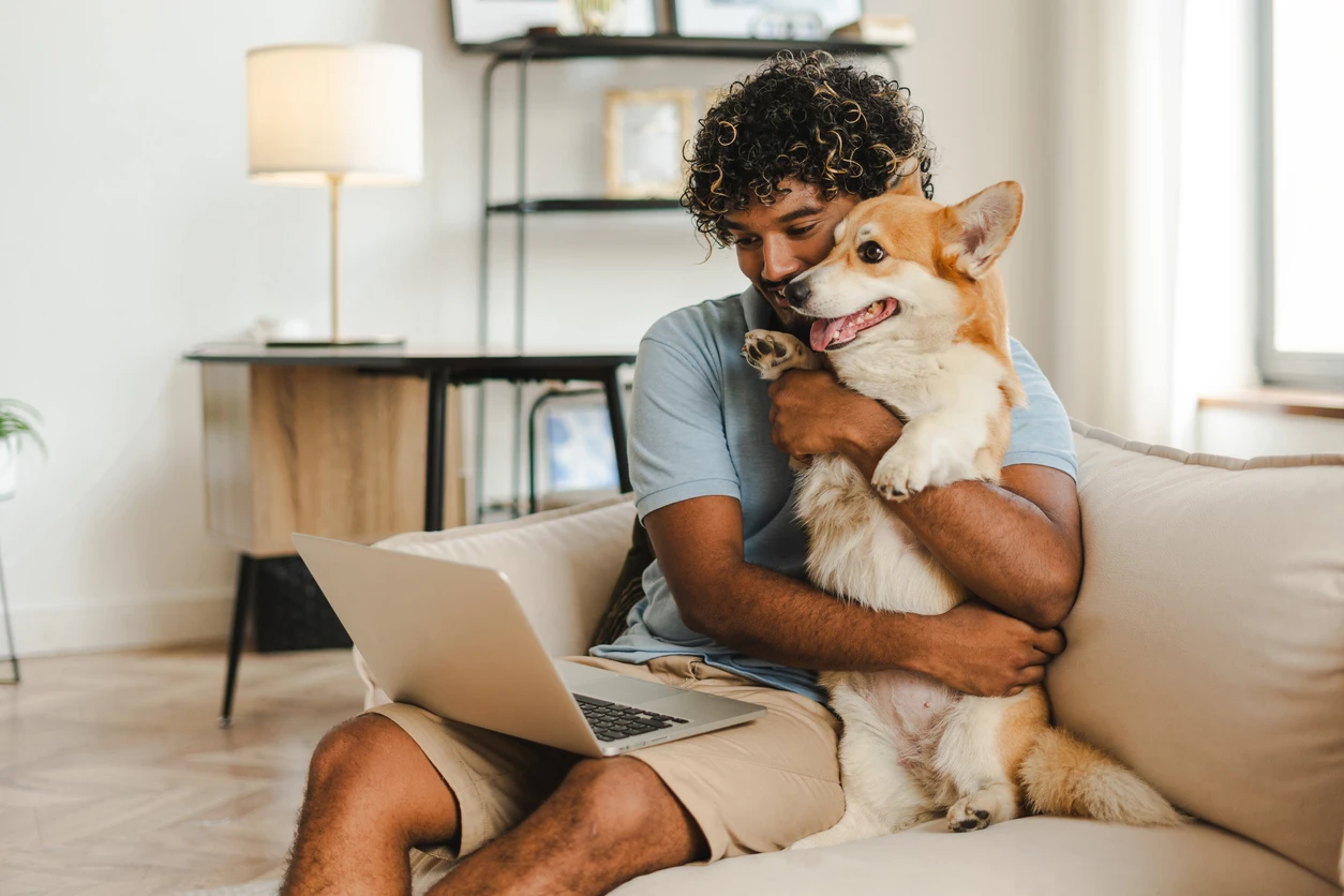 Homeowner with their dog on a video chat.