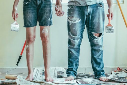 couple covered in paint from household repair work