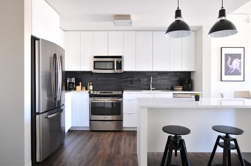 Stainless steel kitchen appliances in large modern home kitchen